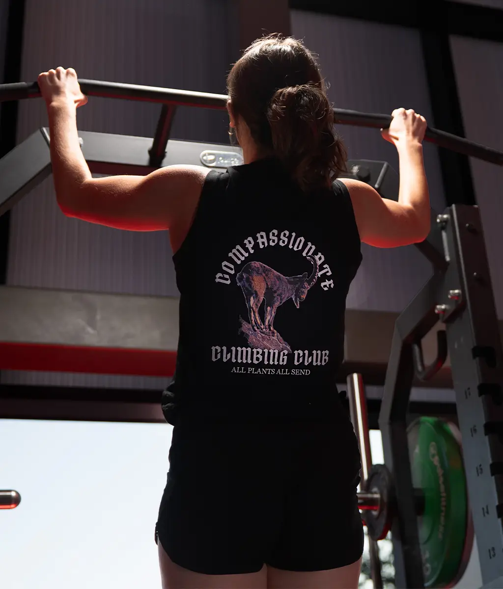 woman doing pullups in a plantbeast tank top