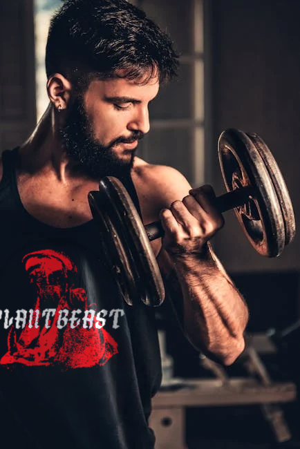 Bearded man in gym lifting a heavy dumbbell, showcasing strength and fitness.